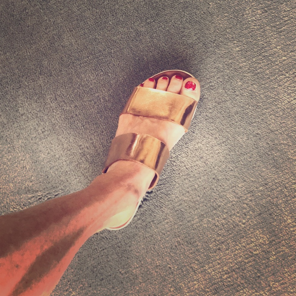 Metallic gold flip flops